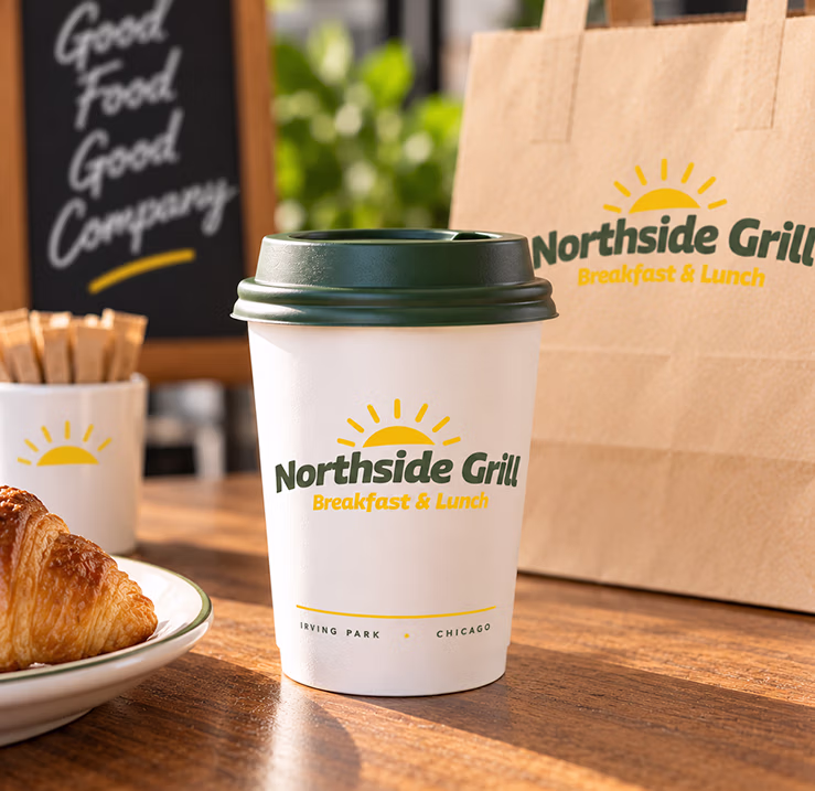 Northside Grill branded coffee cup and takeout packaging featuring the new restaurant identity