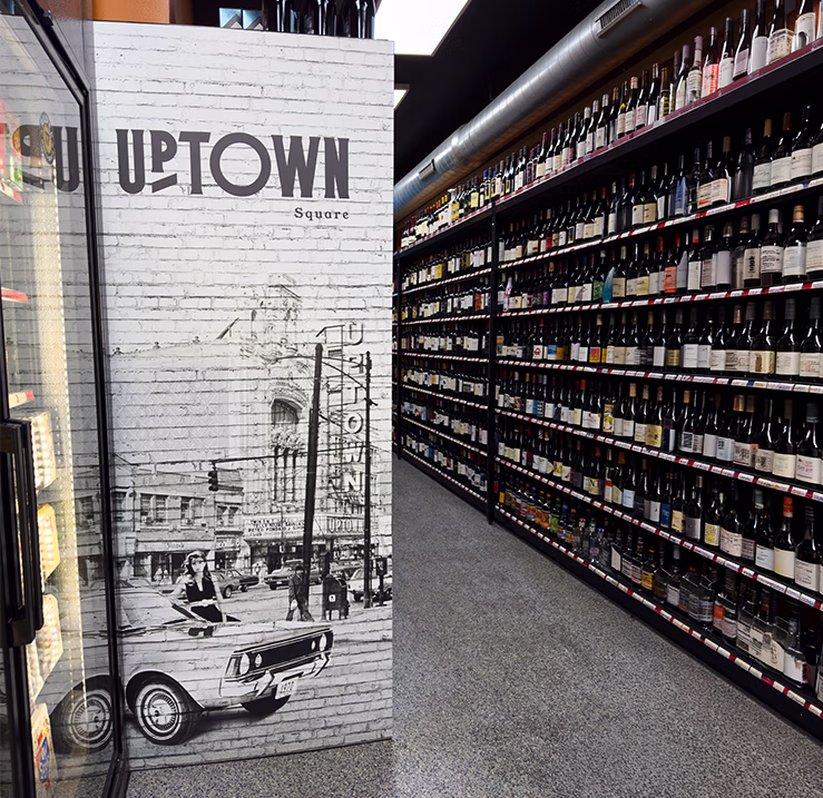 Rupee Wine & Spirits interior featuring custom Uptown Chicago wall graphics beside the wine selection.