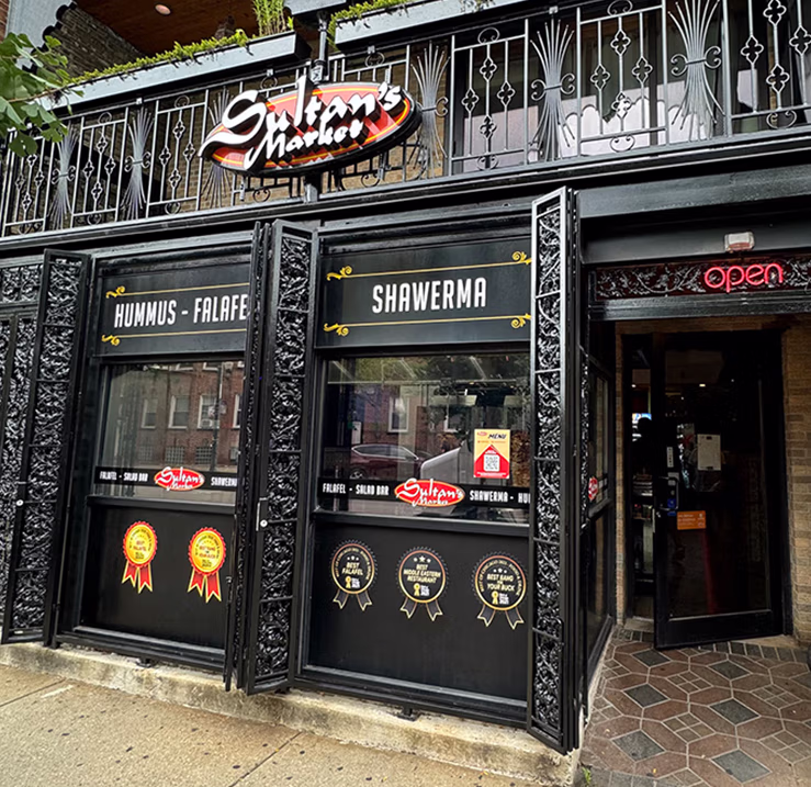 Sultan’s Market Pilsen storefront in Chicago featuring dimensional illuminated restaurant signage.