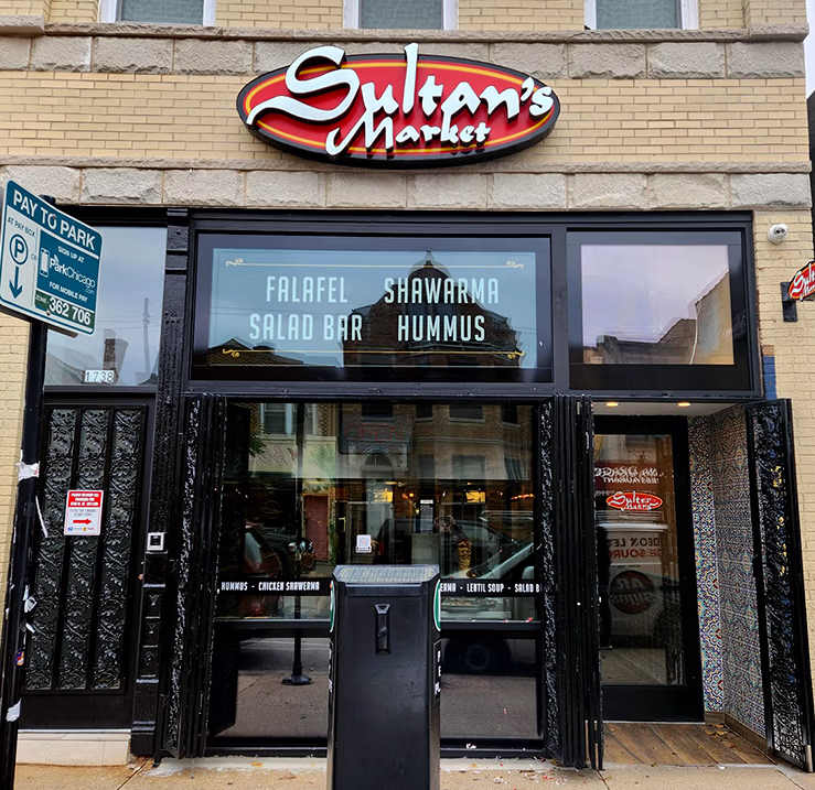 Sultan’s Market Pilsen storefront in Chicago featuring dimensional illuminated restaurant signage.